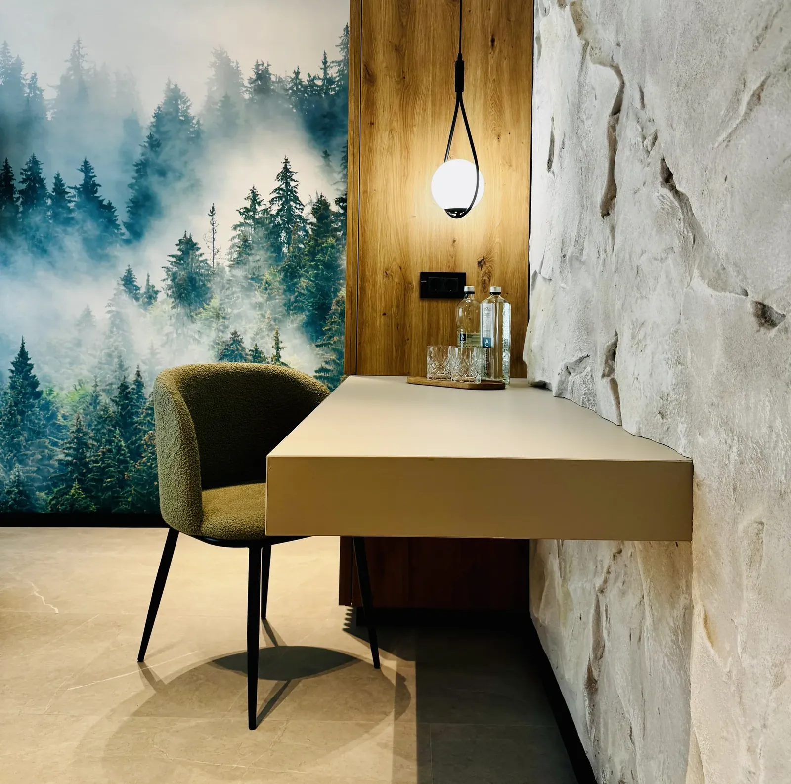 Desk with natural stone feature wall, green chair and lamp, room at MAPAMONT Văliug