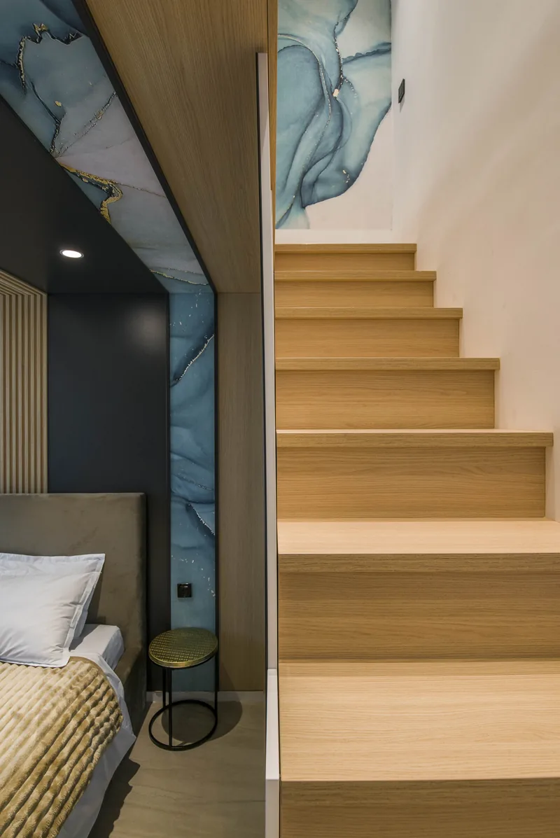 Wooden staircase to the mezzanine, beside a wall of blue-toned natural stone, Family Room MAPAMONT Văliug